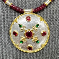 Megan Arnold - Silver and 22ct gold pendant with rubies, emeralds and granulation.